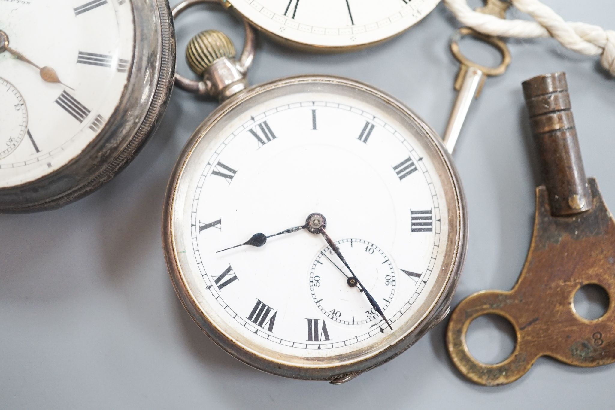 A late Victorian silver keywind open faced pocket watch, retailed by Cornish, Oakehampton, one other silver pocket watch and a pocket watch movement.